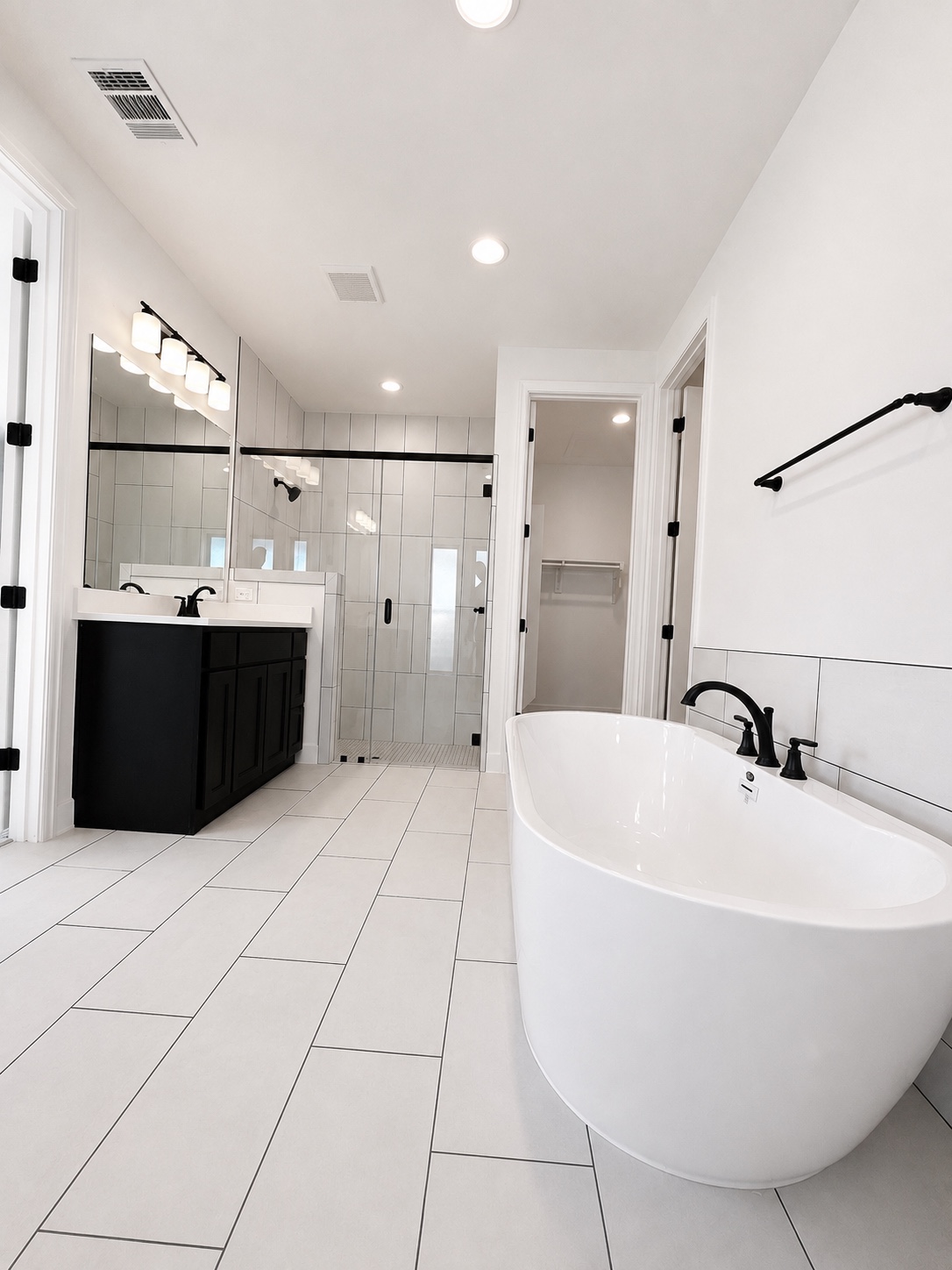 Bathroom with tub and glass shower