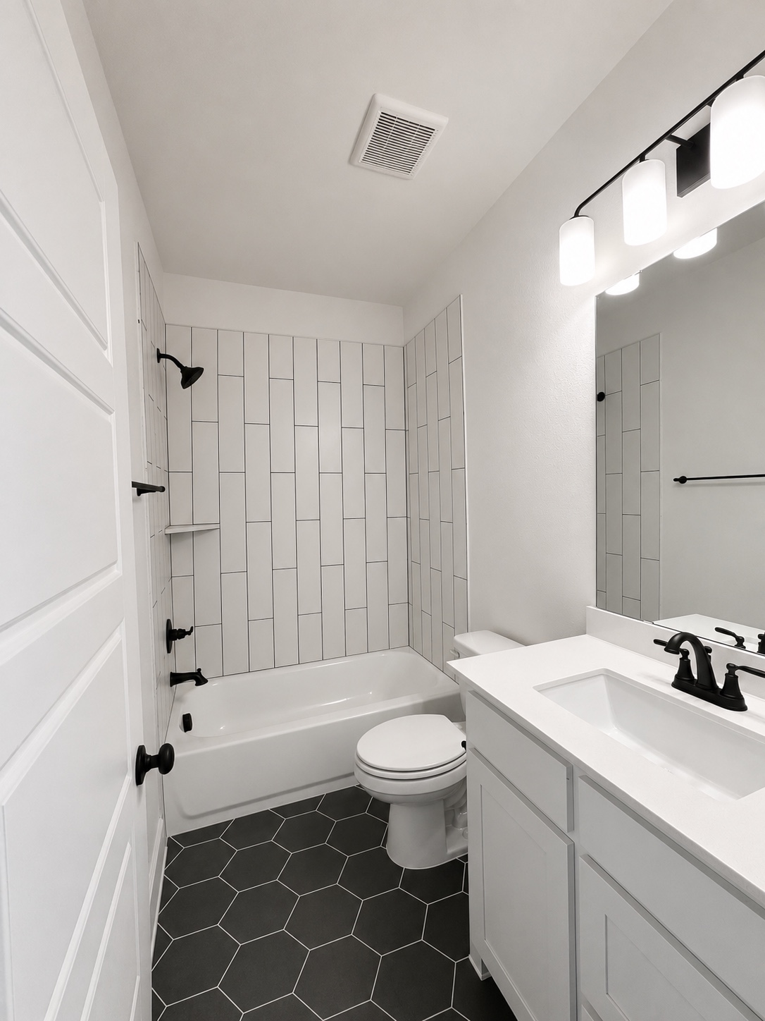 Bathroom vanity and tiled shower